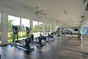 a gym with rows of treadmills and elliptical machines at Explore Nature & Beaches! Nuevo Nayarit Condo in Nuevo Nayarit