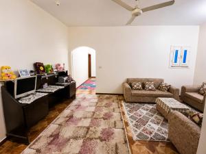 a living room with a couch and a tv at The Blue House in Safaga
