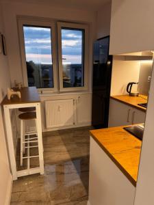 a kitchen with a counter and a window at Apartament Piękna in Łomża +11 photos