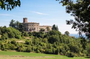 a castle on top of a hill with trees at Castello di Tabiano in Tabiano