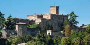 a castle on top of a hill with trees at Castello di Tabiano in Tabiano
