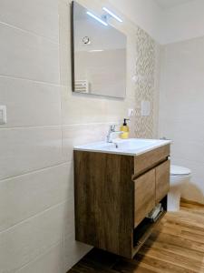a bathroom with a sink and a mirror at Alloggio turistico All'Ombra della Torre in Viterbo +12 photos