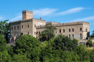 a castle on a hill with trees in front at Castello di Tabiano in Tabiano