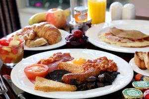 a table with plates of breakfast food on it at B/W Plus Buxton Lee Wood Hotel in Buxton