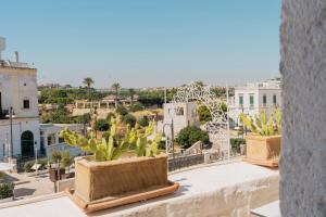 a view of a city from the roof of a building at Antico Mondo Rooms & Suites in Polignano a Mare