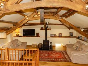 a living room with two couches and a wood stove at The Water Mill at Boyton Mill in Launceston