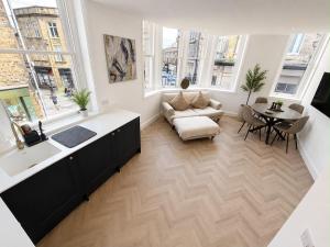 a large living room with a table and a couch at Castle Chambers Serviced Apartments in Lancaster