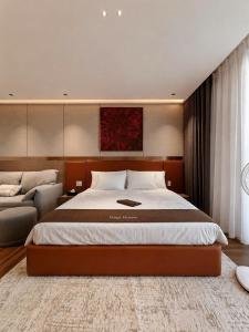 a bedroom with a large bed and a couch at The Pathway Sầm Sơn in Sầm Sơn +38 photos