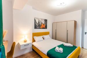 a small bedroom with a bed and a cabinet at Apartament23 Sibiu in Şelimbăr