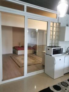a kitchen with a sliding glass door leading to a bedroom at PRISHTINA Stay in Prishtinë