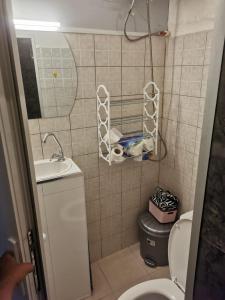 a bathroom with a toilet and a sink and a mirror at PRISHTINA Stay in Prishtinë