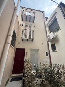 an apartment building with a door and a balcony at Alley House in Cefalù
