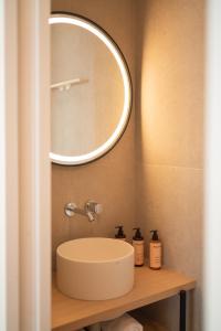 a bathroom with a sink and a mirror at Domaine des Grands Sables, Île Groix - Handwritten Collection in Groix +47 photos
