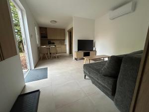 a living room with a couch and a table at Prázdninový domeček in Heřmanice