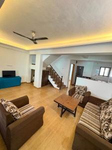 a living room with two couches and a table at 7 Stone in Malavli