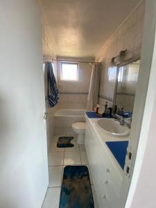a small bathroom with a sink and a toilet at Comfortable apartment steps from Portal Belloto in Quilpué