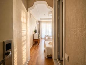 a hallway with two beds in a room at mood beach hotel in Didim