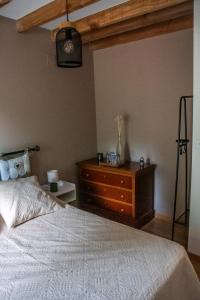 a bedroom with a white bed and a dresser at Lacour in Augignac +10 photos
