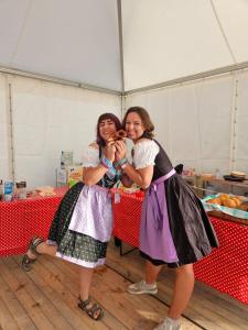 two women standing in front of a table with donuts at Munich Oktoberfest Village Breakfast included by Yes-Trips! in Munich