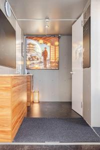a kitchen with a large painting on the wall at Moon Base Tokyo Inn in Tokyo