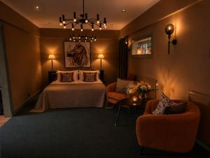a hotel room with a bed and two chairs at The White Brig in Hudiksvall
