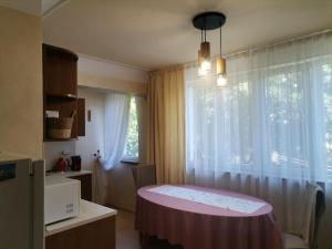 a small room with a bed and a window at Апартамент Граф Игнатиев in Varna City