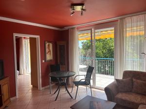 a living room with a couch and a table at Apartman Jasmine in Csopak