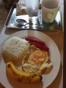 a plate of food with a banana and rice at Era's Garden Homestay in Catmon +15 photos