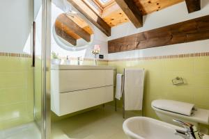 a bathroom with a sink and a toilet and a shower at The Haven Quiet Escape - Panoramic Terrace in Valtournenche +46 photos