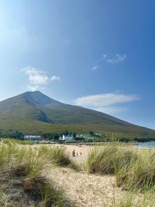 a view of a beach with a mountain in the background at The Strand, Dugort Achill in Achill