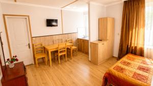 a hotel room with a table and chairs and a bed at Tuz House R3 in Bakuriani