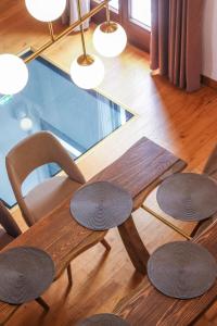 a dining room table with chairs and a glass table at Elia City House in Kavála