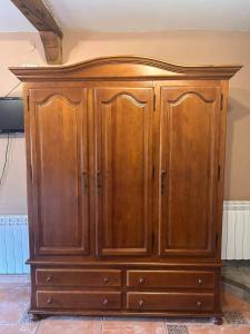 a wooden cabinet is sitting in a room at Casa Rural Villacampa (Nocito) in Nocito