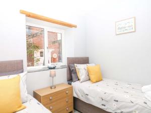 a bedroom with a bed and a window at The Milk Shed in Plymtree