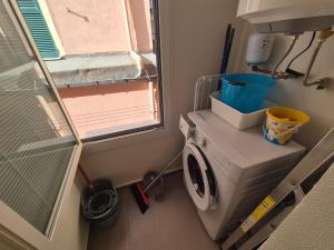 a washing machine in a bathroom with a window at Rezzano 12 in Bonassola +9 photos