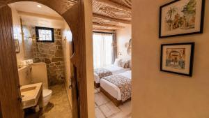 a bedroom with two beds and a bathroom with a sink at Palm Surf & Spa Hotel in Agadir +56 photos