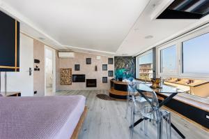 a bedroom with a bed and a desk and windows at Tropea Solemare in Tropea