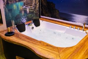 a bathroom with a bath tub with a large window at Tropea Solemare in Tropea +57 photos