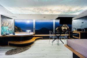 a bedroom with a tub and a dining room at Tropea Solemare in Tropea