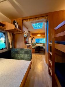 an interior of an rv with a kitchen and a living room at Kanukamp, Kemping nad rzeką in Tarnogóra
