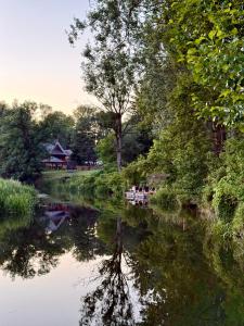 a group of people sitting on a boat on a river at Kanukamp, Kemping nad rzeką in Tarnogóra