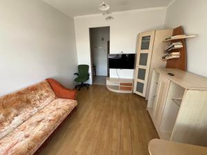 a living room with a couch and a desk at Budget Room Vilnius in Vilnius