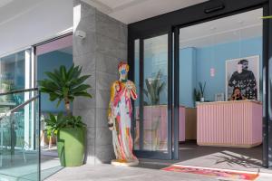 a statue of a woman standing in front of a building at Hotel Majorca in Gabicce Mare