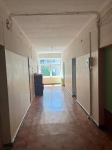 an empty hallway of an office building with a window at Budget Room Vilnius in Vilnius +1 photo