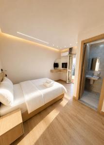 a bedroom with a large white bed and a bathroom at Landmark Hostel Cairo in Cairo