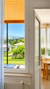a room with a window with a view of a yard at Tuz House R5 in Bakuriani