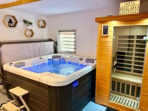 a large jacuzzi tub in a room at Boglárka Vendégház 2fős apartman in Balatonboglár