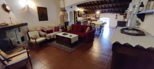 a living room with red chairs and a table at CASALE SPOLETO in Spoleto