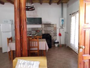 a kitchen and dining room with a table and chairs at Cabaña Samka in Maimará +14 photos