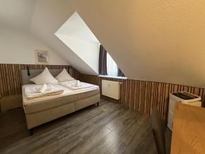 a bedroom with a bed and a window in a attic at Hotel TheCorner in Konstanz